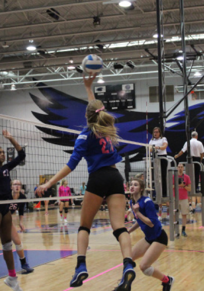 Sophomore Kristin Kaufman tips the ball during the Varsity Dig Pink game against Olathe West. The game took place at Olathe Northwest on October 14.