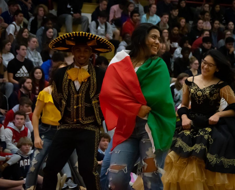 Senior+Ayadan+Knight%2C+Senior+Paola+Valles%2C+and+Junior+Jenny+Chavez+walk+off+the+gym+floor+after+the+Quinceanera+performance+at+the+November+7th+Diversity+Assembly