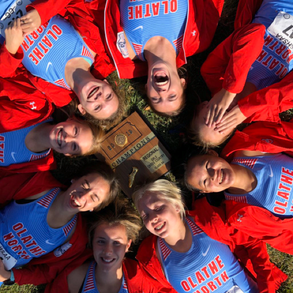 Varsity Cross Country girls Kira Almsberger, Alexis Dockstader, Halle Heeran, Irina Honc, Jillian Kiefer, Zoey Schillinger, Kaylee Tobaben, and Sarah Whitaker posing with their award after winning regionals.