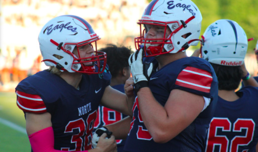 Sophomore Keegan
Wright and Junior
Braden Hales
conversing before the
Varisty football game
against Shawnee
Mission Northwest on
September 9th. The
Olathe North Eagles
won with a score of
49-35. | Photo by Paige
Keith