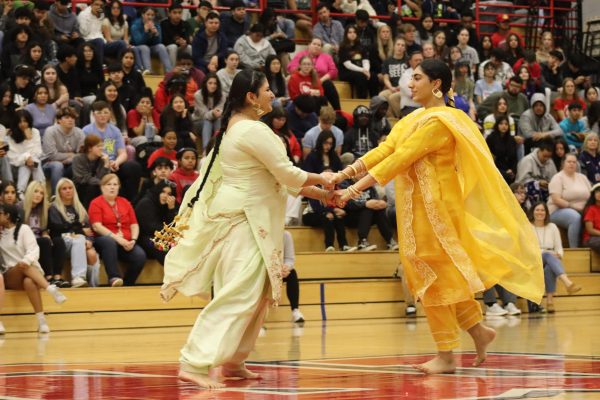 Two students perform a traditional dance together